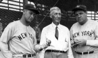 Babe Ruth in a New York jersey standing with two other men