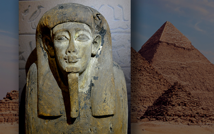 Ancient Egyptian wooden sarcophagus with a carved human face, set against a backdrop of the Giza pyramids