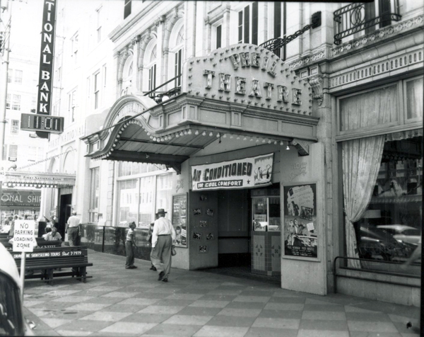 Exterior of a vintage movie theatre with a marquee reading 