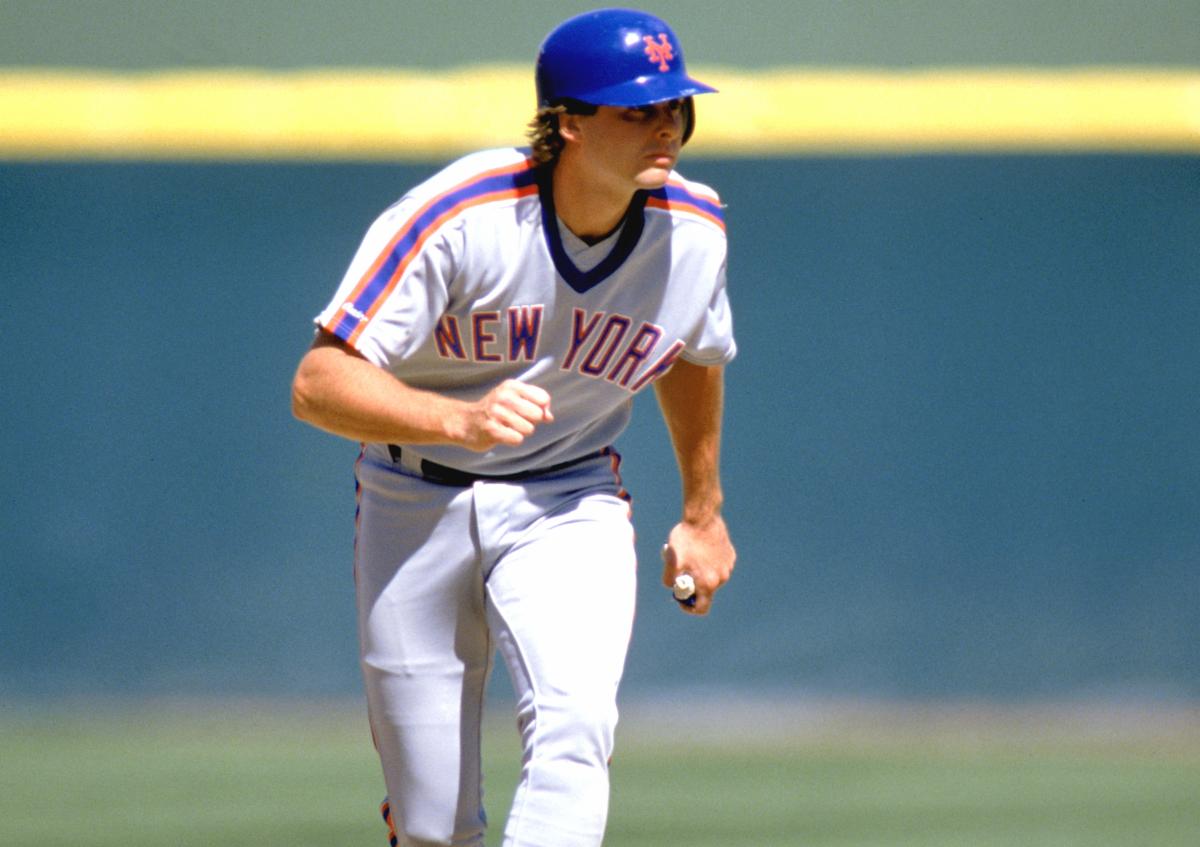 New York Mets player running the bases in a gray away uniform and blue helmet