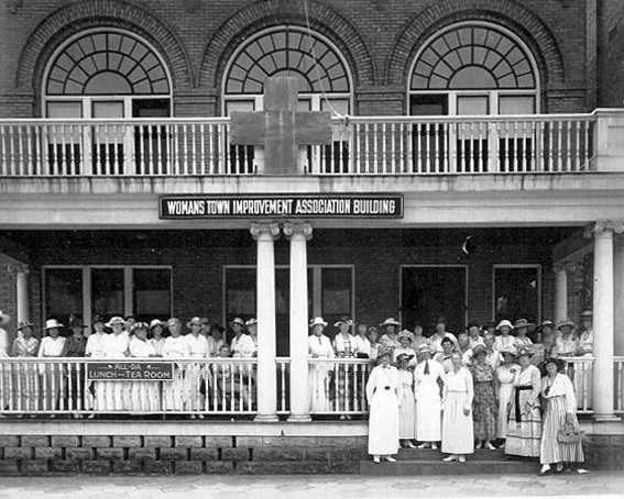 Group of women gathered outside the Woman's Town Improvement Association Building, an early 20th-century civic organization headquarters