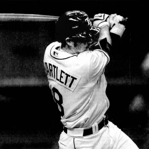 Baseball player, Jason Bartlett, holds a bat in mid-swing