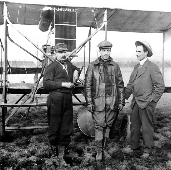 Albert Berry, Tony Jannus, and one other person stand in front of a plane