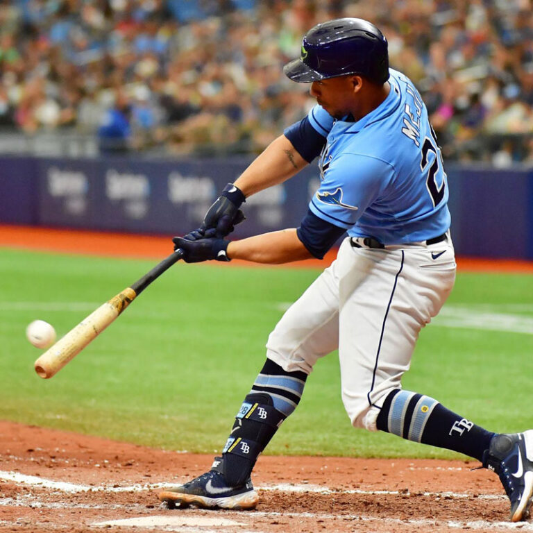 Tampa Bay Rays player Francisco Mejía swinging a bat as it is about to contact with a baseball