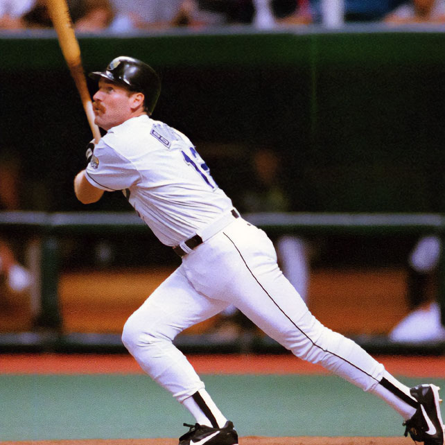 Wade Boggs runs with a bat in his hand while looking up