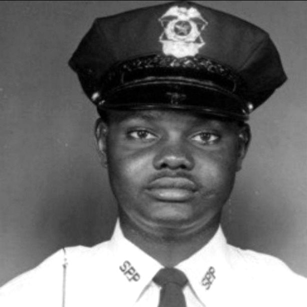 Photo of Leon Jackson, a young Black man in white police uniform with 