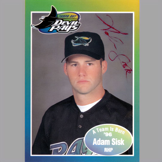 Baseball card with young player, Adam Sisk, wearing a black shirt and black hat.