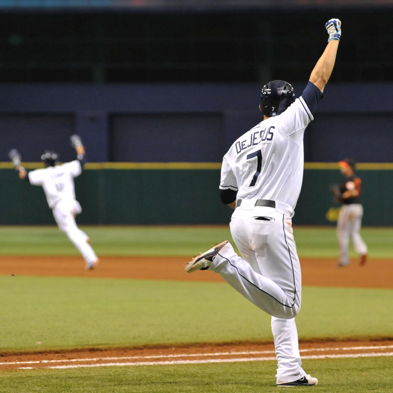 Tampa Bay Rays baseball player, De Jesus, running on the field with his arm in the air