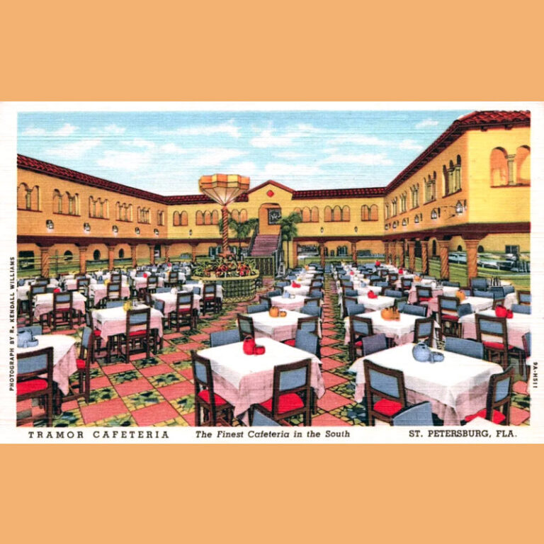 View of a courtyard in a Mediterranean Revival building with dining tables placed in neat rows