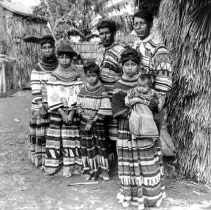 A Seminole family with adults and children wearing traditional clothing