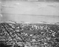 Aerial view looking southeast over downtown, with Mirror Lake in the center. Million Dollar Pier is visible on the left, and the Railroad pier is in the center. Albert Whitted airport is to the right. c. 1930 Aerial view looking southeast over downtown, with Mirror Lake in the center. Million Dollar Pier is visible on the left, and the Railroad pier is in the center. Albert Whitted airport is to the right. c. 1930