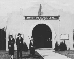 Three people standing in front of the Sunshine Roque Club, Inc. building in a vintage black-and-white photo