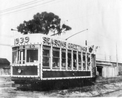 Municipal Railway trolley, car #45, decorated for Christmas. Background appears to be at the car barns. c. 1939