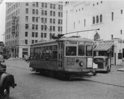 Trolley on 5th St S between 1st Ave S & Central Ave. Florida Power building in background. c. 1940
