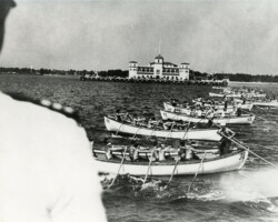 Merchant Marine recruits racing whaleboats past the pier as part of training during World War II. c. 1944