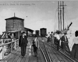 View looking east toward the head of the ACL (Railroad) Pier, near water tank and sheds. Sailing vessel at dock. c. 1904