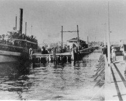 Electric Pier and Municipal Pier, side by side. Favorite Line steamer alongside, trolley on pier. c. 1914