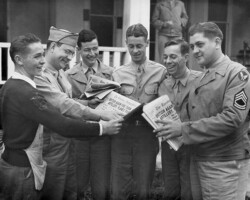 Army Air Corps men and newsboy looking at Evening Independent during World War II. c. 1943