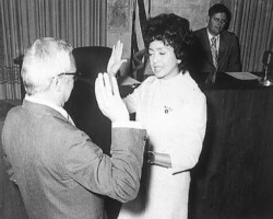 C. Bette Wimbish taking oath of office for City Council. Wimbish was the first Black woman to sit on City Council. c. 1969.