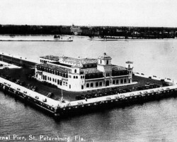 Historic aerial view of the Recreational Pier in St. Petersburg, Florida, showing a large waterfront building surrounded by water on three sides