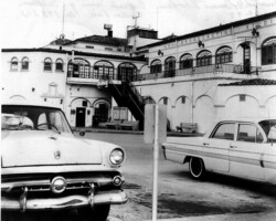 Vintage black-and-white photo of WSB Broadcasting Studios exterior with 1950s-era cars parked in front