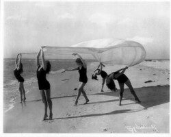 Women in swimsuits dance on beach for a promotional photo. c. 1930. Women in swimsuits dance on beach for a promotional photo. c. 1930.