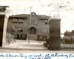 Davis Elementary School, St. Petersburg, Florida, March 10, 1938, showing the two-story brick building entrance with flagpole and swing set