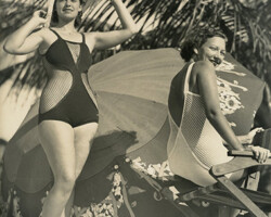 Two Cheesecake/Bathing Beauties pose with a beach umbrella in the background. Date unknown, probably 1920s-1930s.