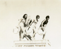Three Cheesecake/Bathing Beauties standing on top of a life guard tower in Spa Beach. Date unknown, probably 1920s-1930s.
